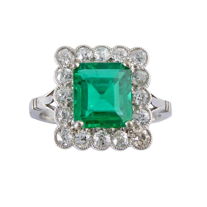 Emerald and diamond rectangular cluster ring, the cut corner emerald of step cut, approximately 1.45ct, | MasterArt